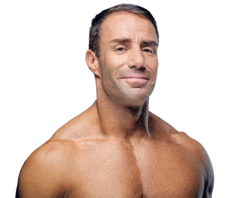 Smiling muscular man with short dark hair and bare chest against black background.