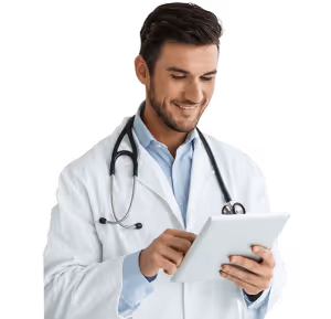 Smiling male doctor in white coat using a tablet device.
